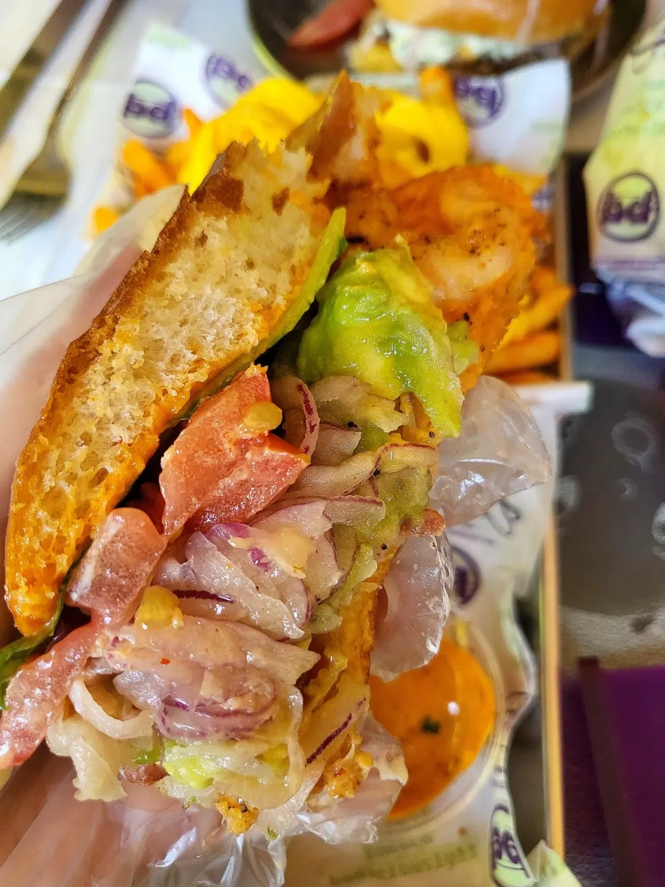 A bite of the Grilled Shrimp Avocado burger