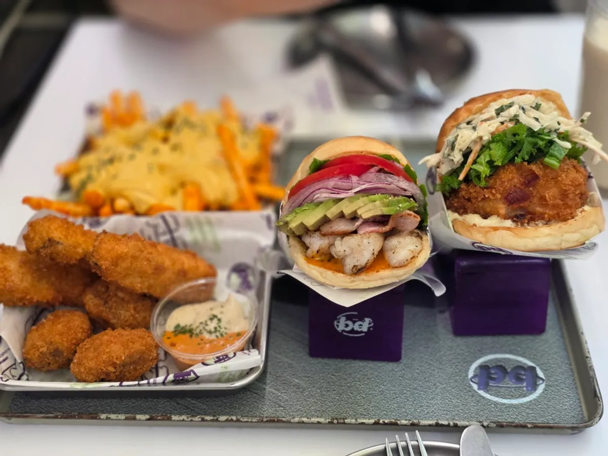A table spread with the thick-topped shrimp burger sets