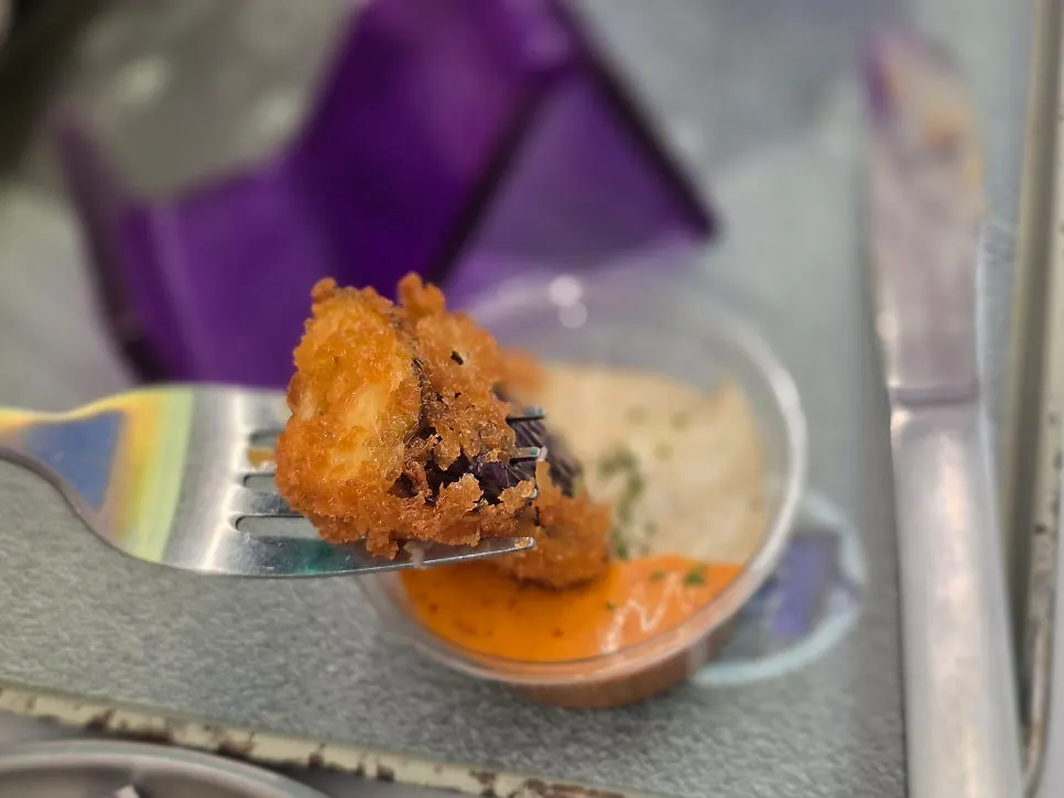 Close-up of eggplant fritters dipped in sauce