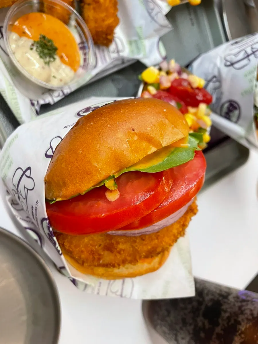 Cross-section of the Sriracha Shrimp Burger showing the fried shrimp patty
