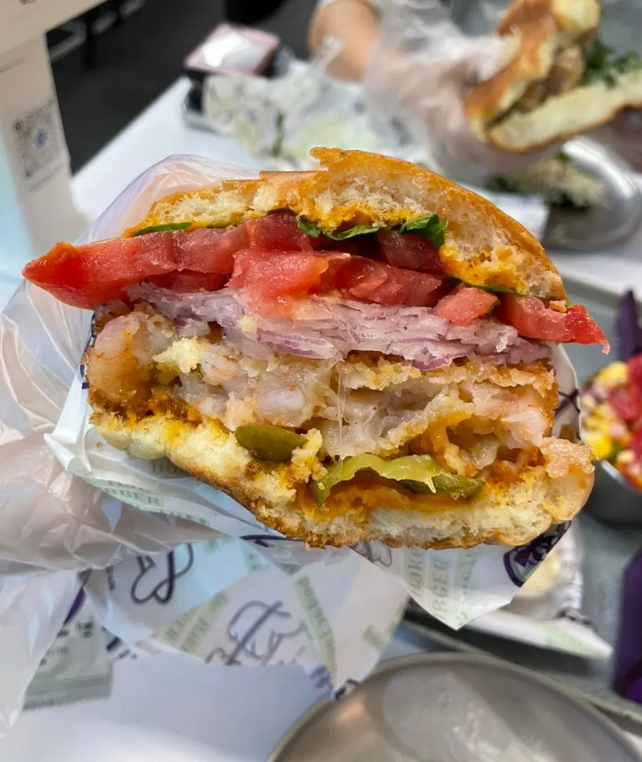 A bite taken out of the Sriracha Shrimp Burger