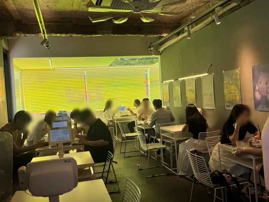 Interior of bd Burger Seongsu with tables for two and four