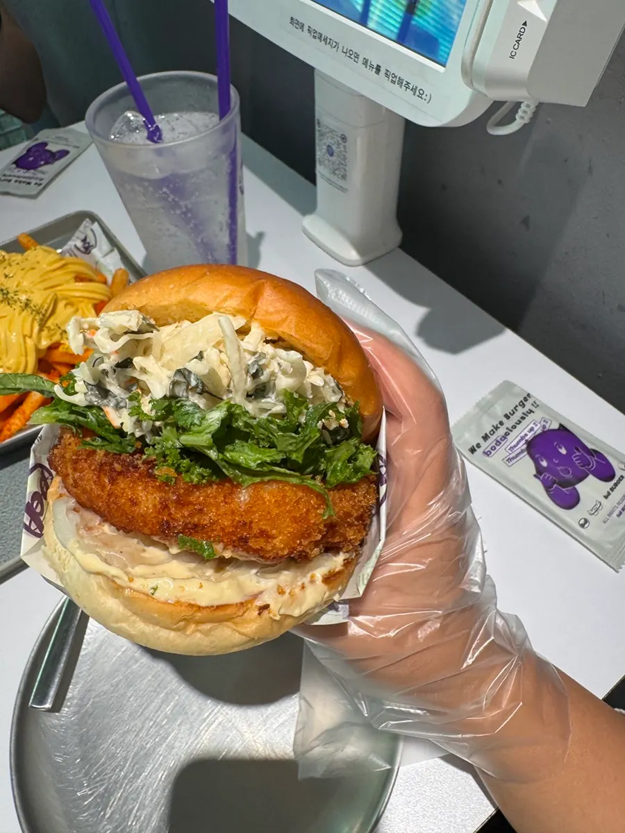 Holding the Wasabi Shrimp burger to eat