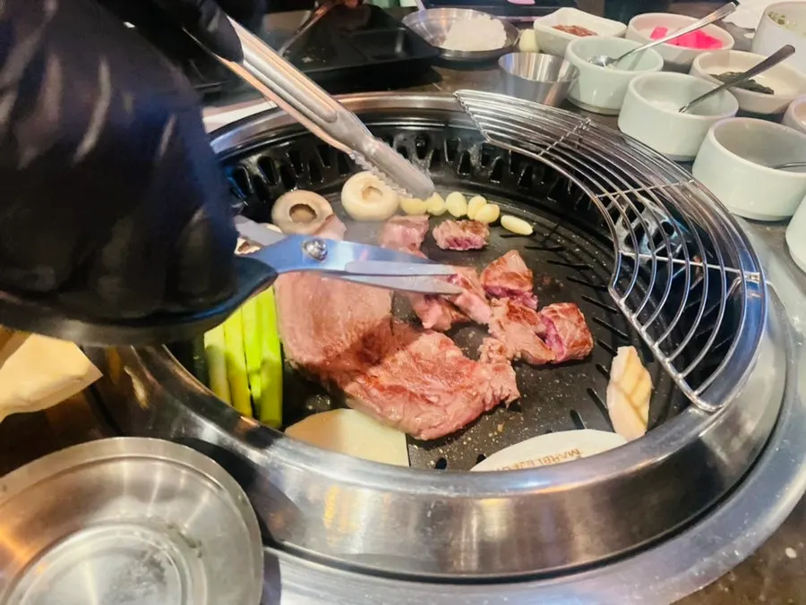 A staff member grilling the meat