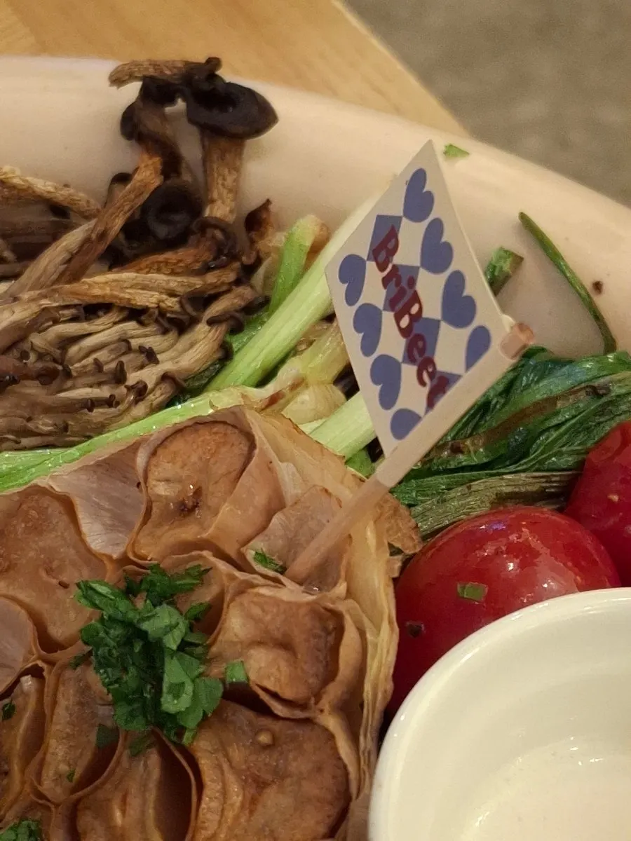 A piece of steak dipped in white sauce