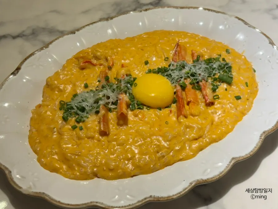 A plate of spicy crab risotto topped with crab