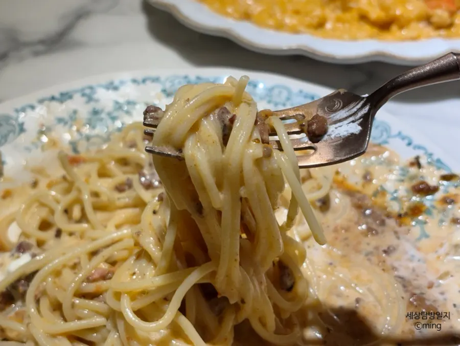 Fork lifting a bite of Darak rosé pasta
