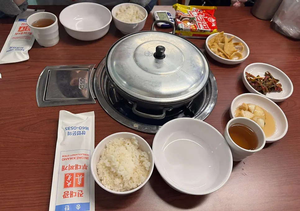 A spread of millet rice and basic side dishes including fish cake