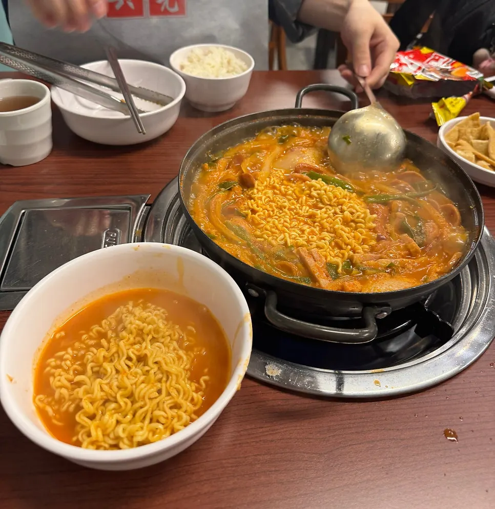 A plate of budae jjigae served with its rich broth