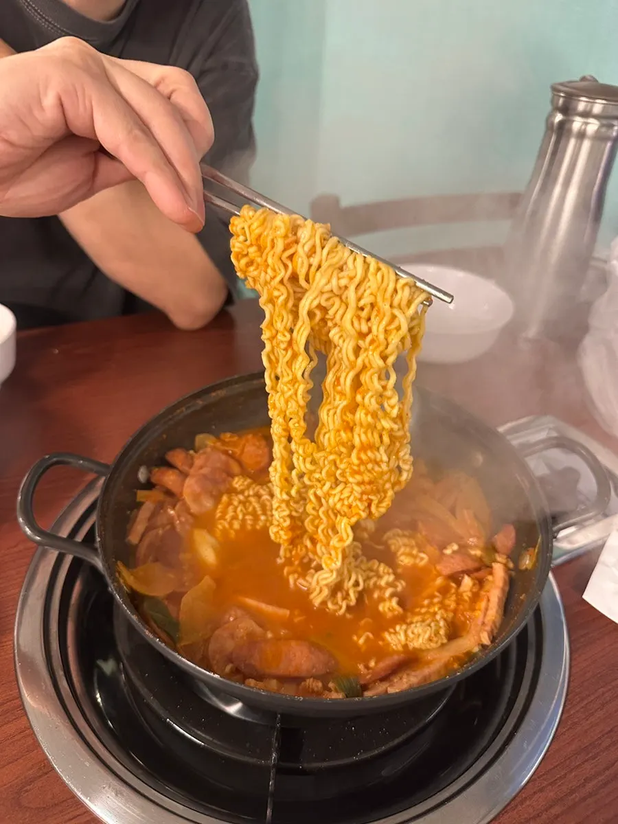The Jin Ramen sarì lifted out of the broth once cooked through
