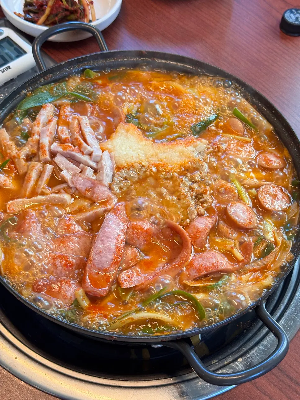 Pot of budae jjigae for three, packed with ham
