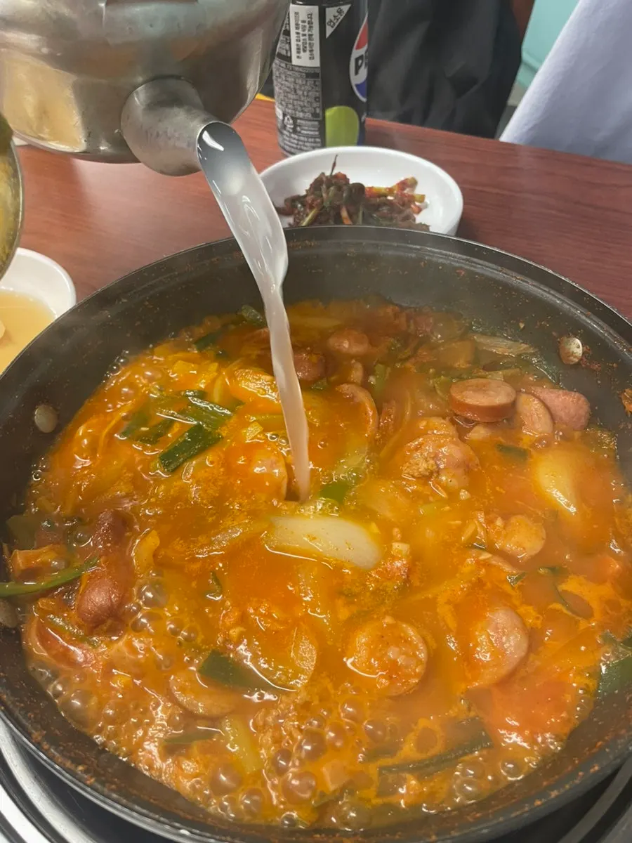 A spoonful of army stew eaten together with rice