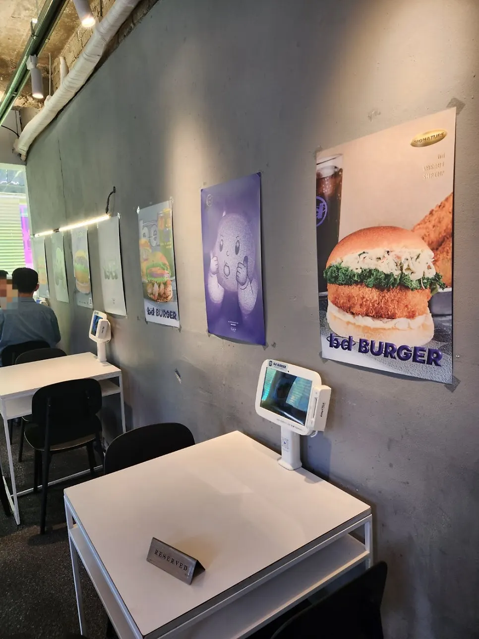 Casual restaurant interior with burger posters