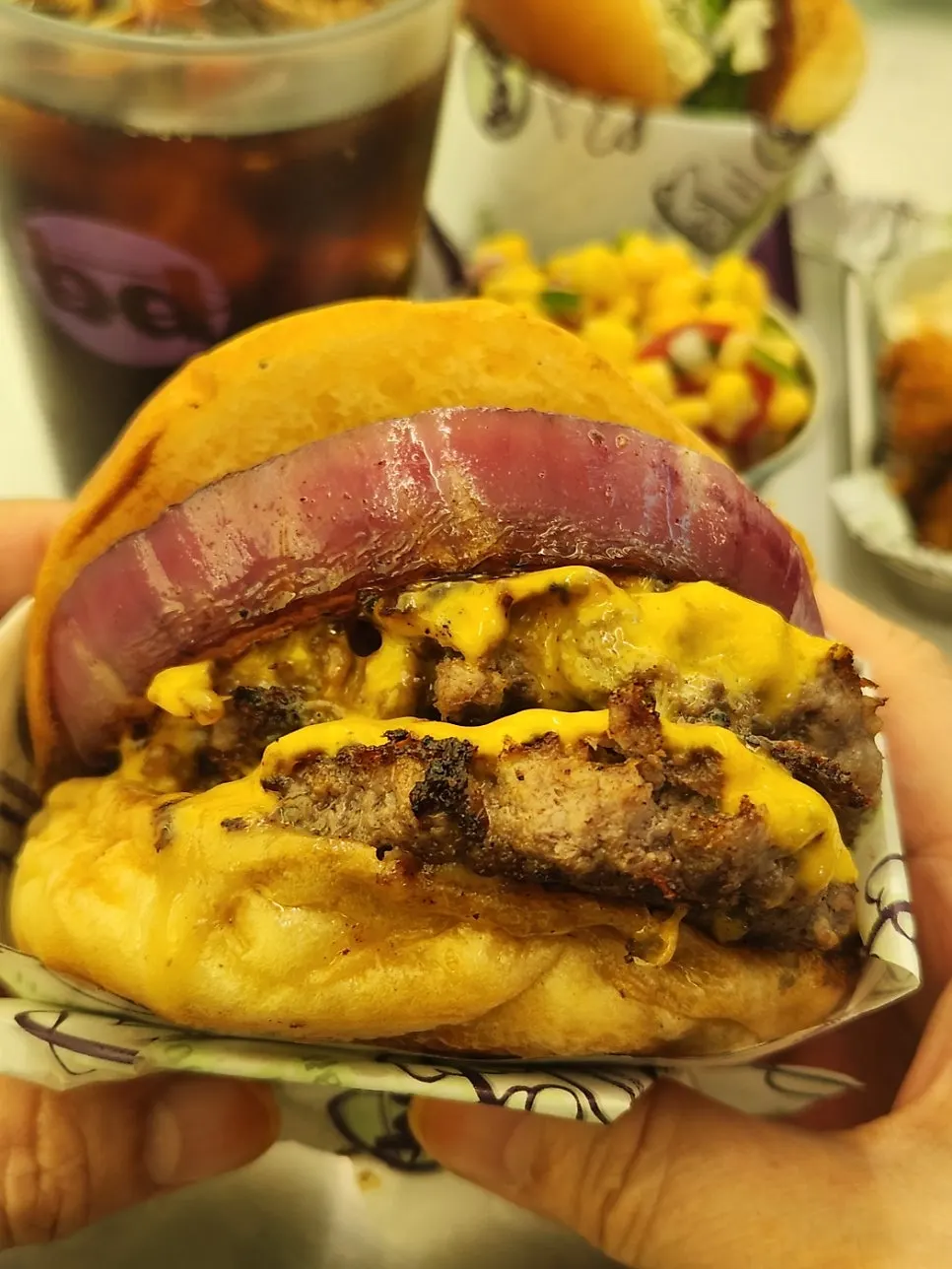 Double cheese burger with patty, cheese, and grilled red onions