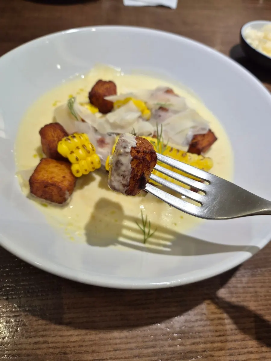 Fried gnocchi topped with corn and cheese