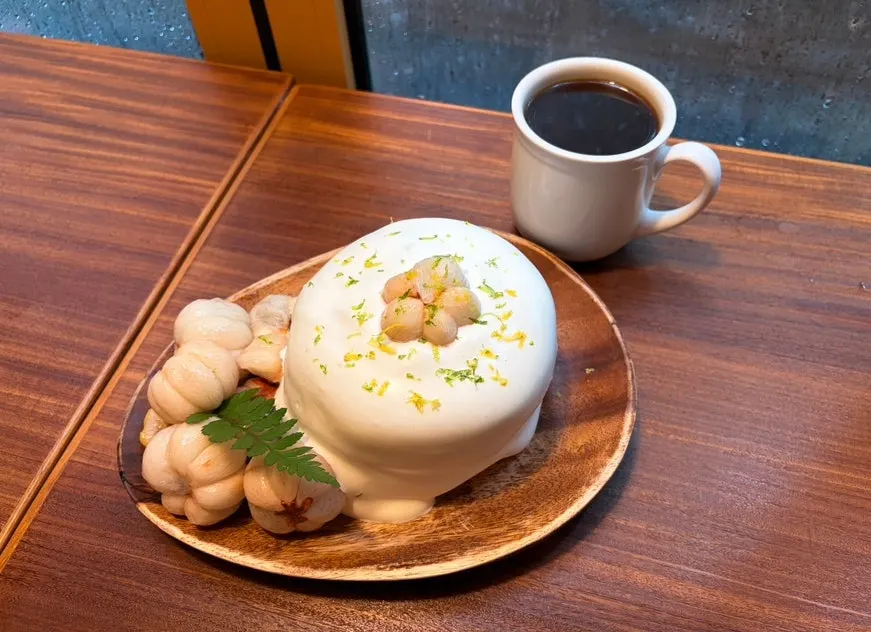 A bite of mango steen soufflé lifted on a fork