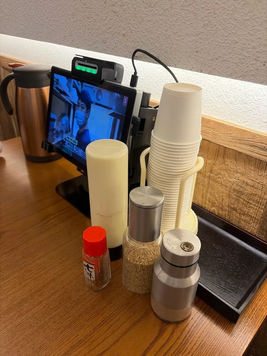 Spicy powder, sesame seeds, pepper, and salad sauce on the table