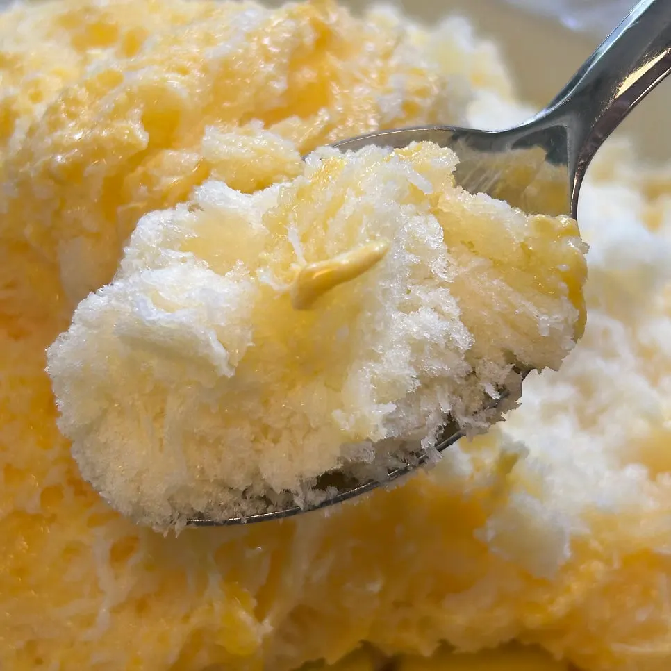 Soft shaved ice drizzled with mango syrup