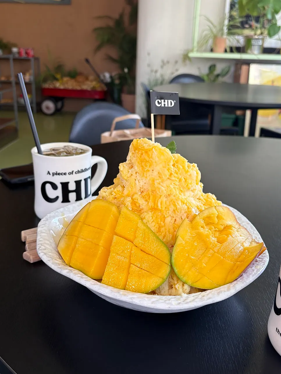 Taiwanese-style mango bingsu served in a large bowl at Childish