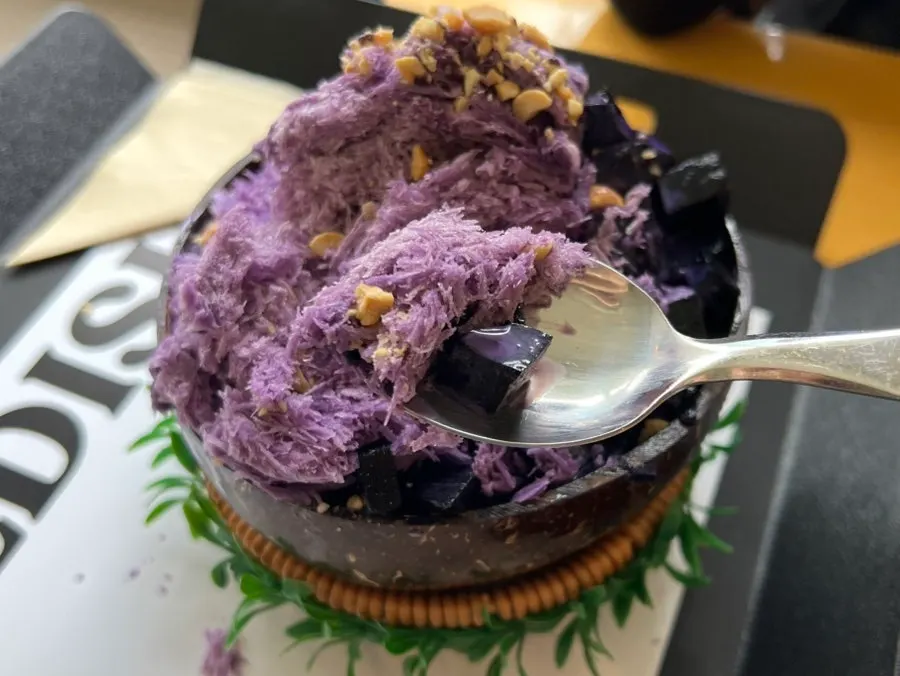 Close-up of ube bingsu topped with nuts and jelly