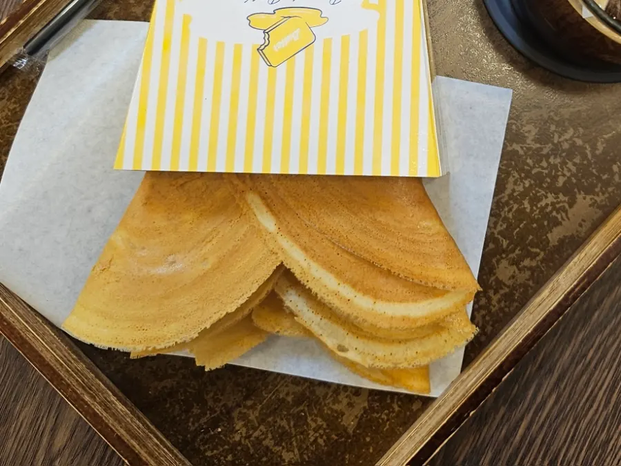 Bocado in paper wrapping with coffee