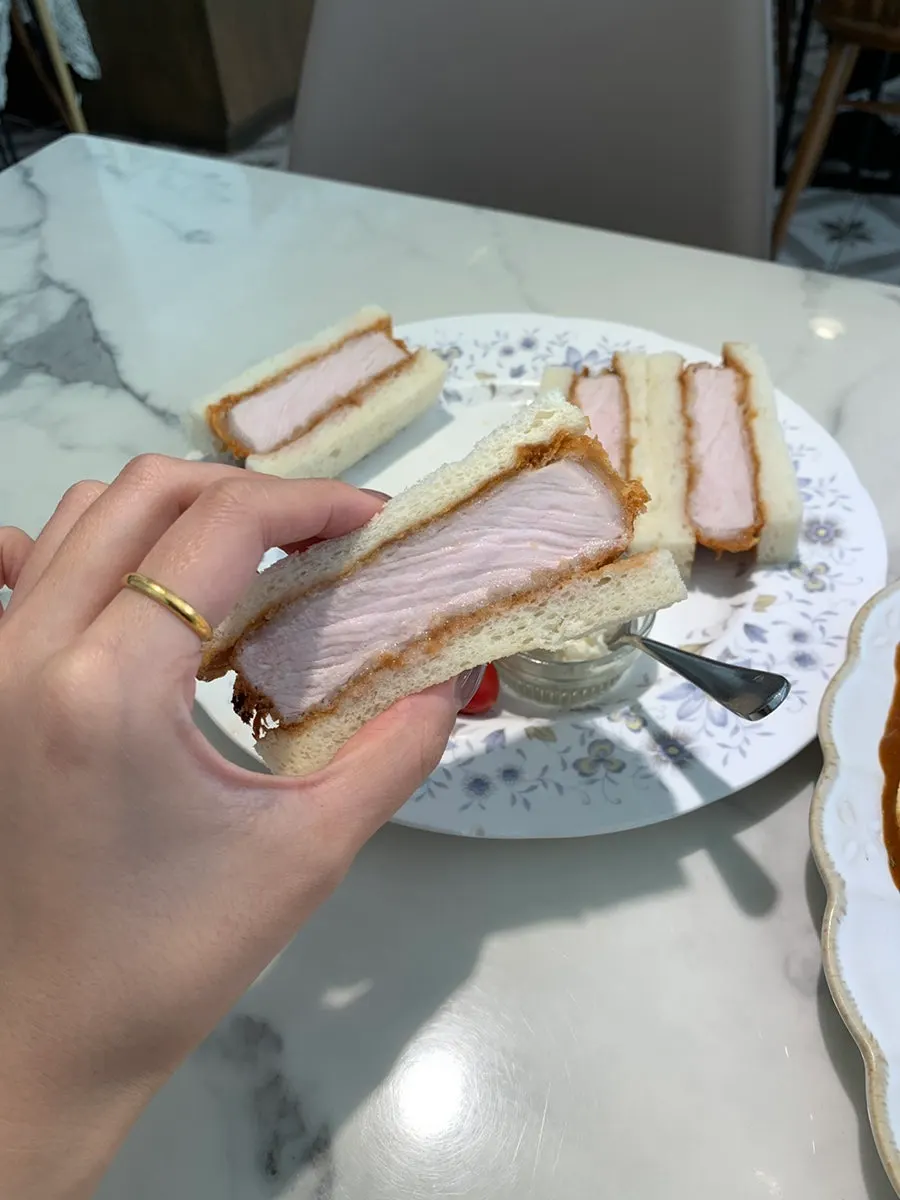 Cross-section of the katsu sando showing the thick meat cutlet