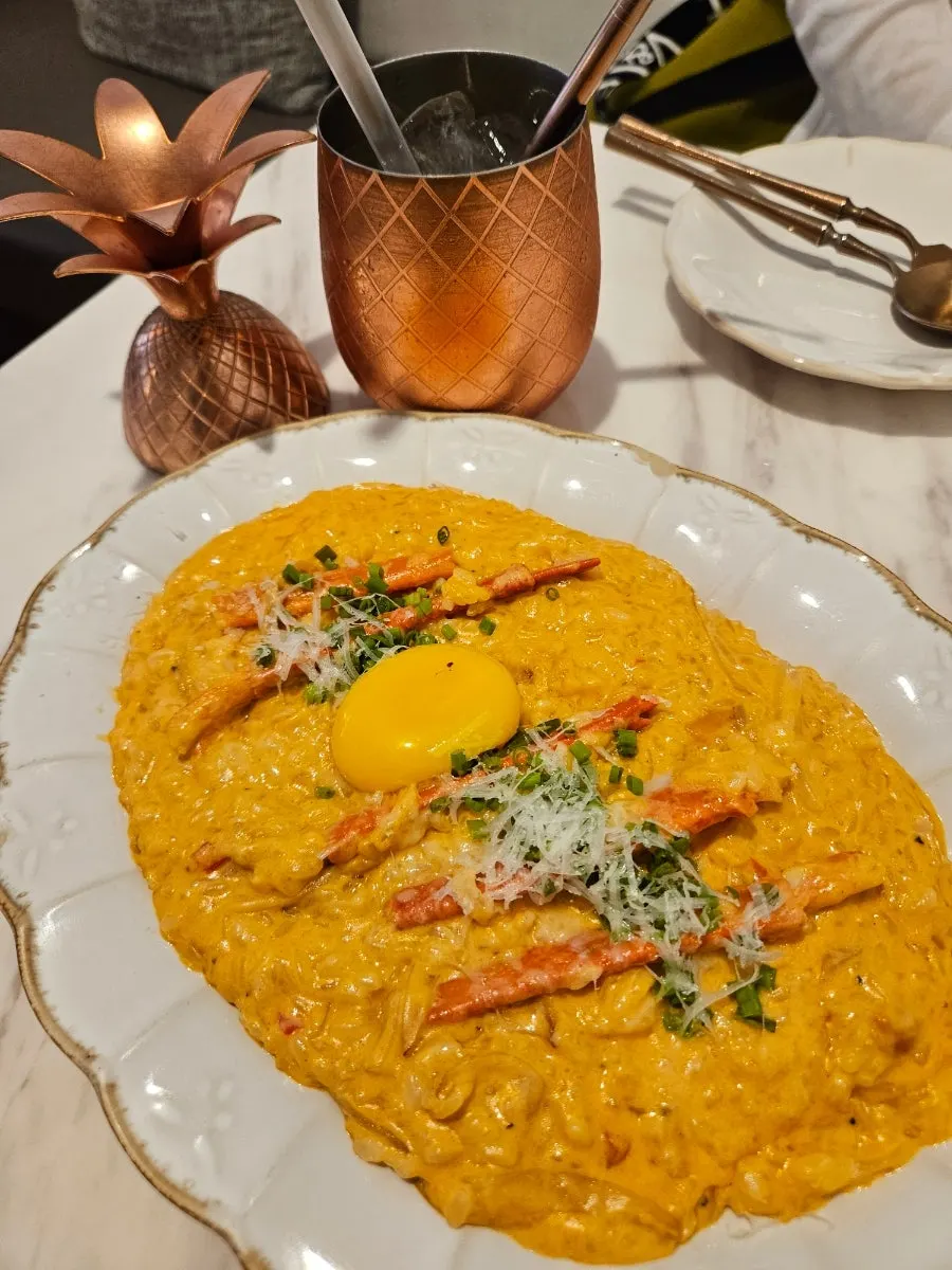 Spicy crab risotto topped with crab meat and egg yolk