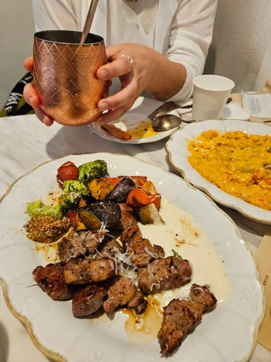 Steak and risotto served together at the table