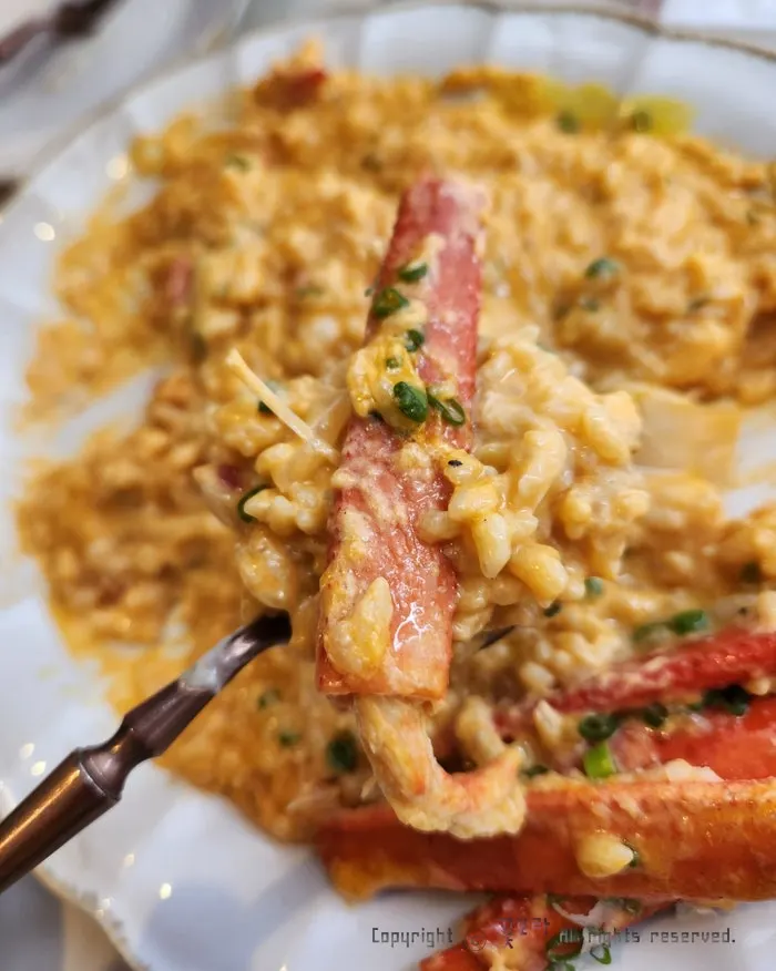 Spicy crab risotto topped with a snow crab leg