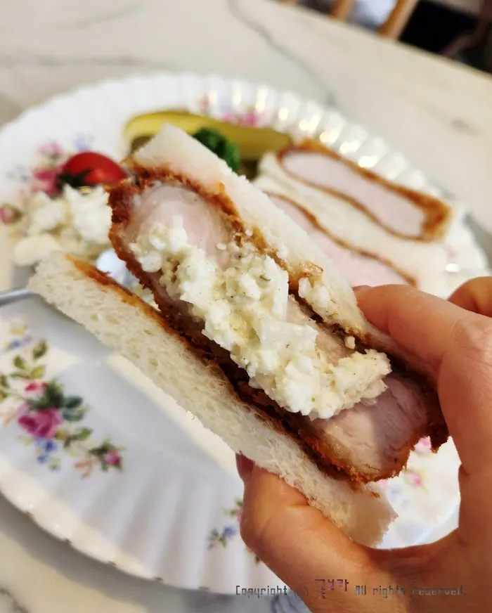 Cross-section of katsu sando topped with coleslaw