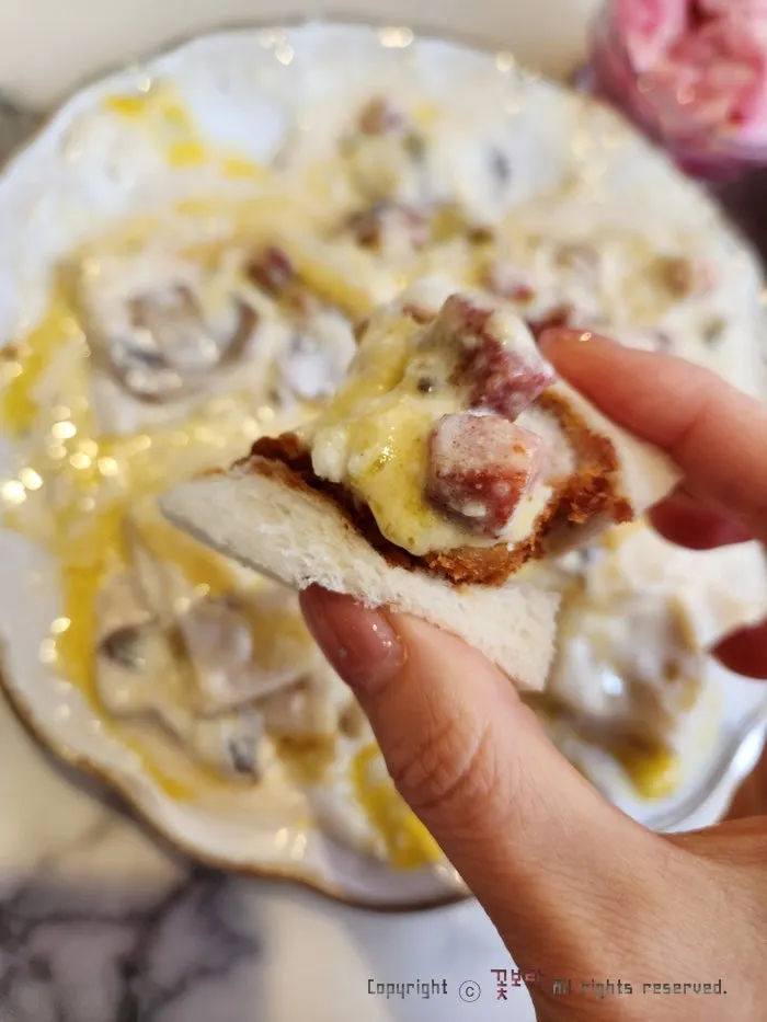 Katsu sando eaten with carbonara sauce on top