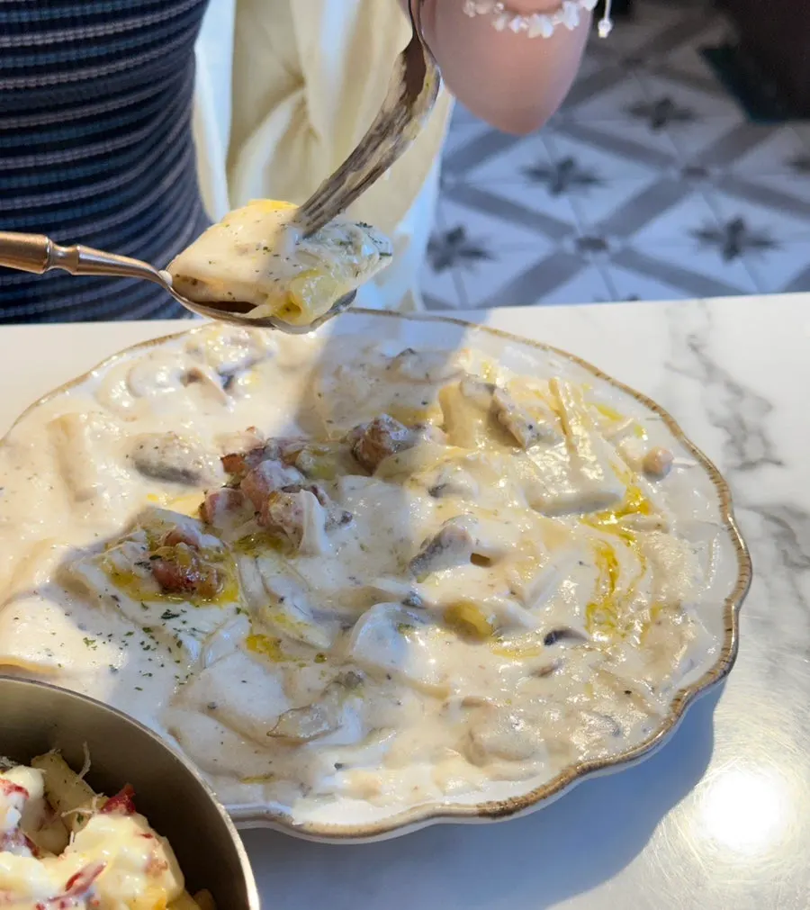 Flat carbonara topped with egg yolk