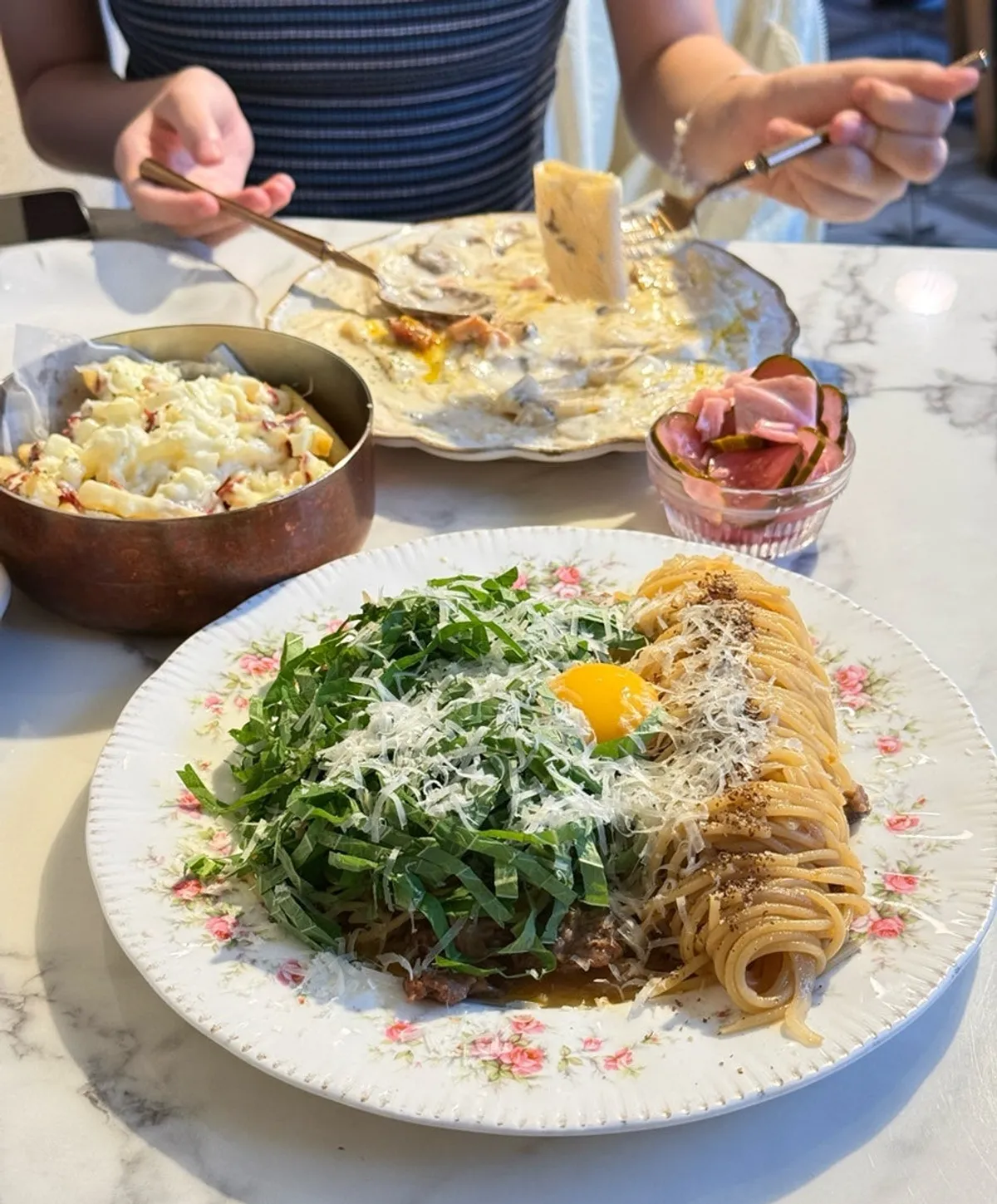 A bite of the thick flat noodle carbonara