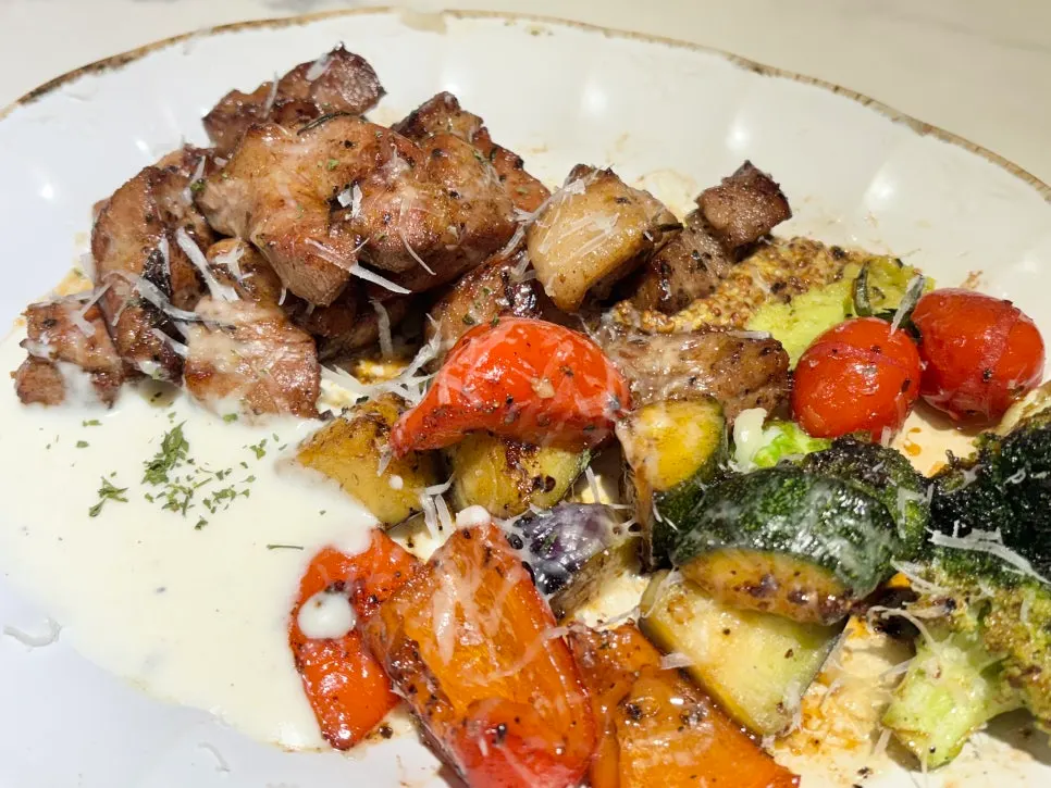 The chap-mokssal pork steak served with grilled vegetables and mashed potatoes