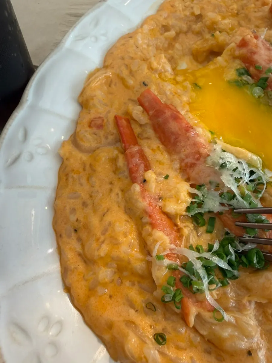 A partially eaten plate of spicy crab risotto