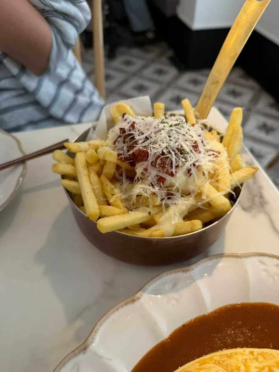 Close-up of fries topped with cream sauce