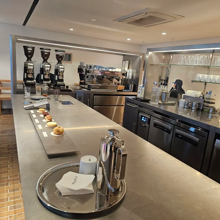 Interior of T Coffee with wood-tone tables and chairs