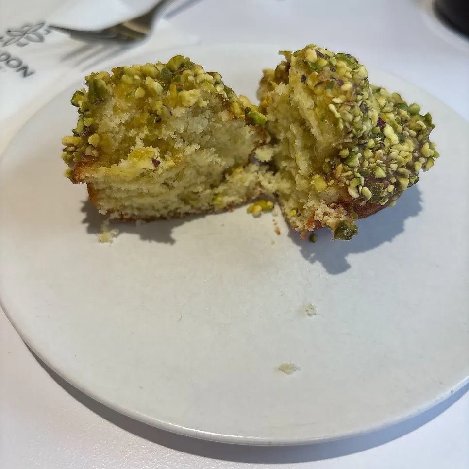 Madeleine topped generously with crushed pistachio