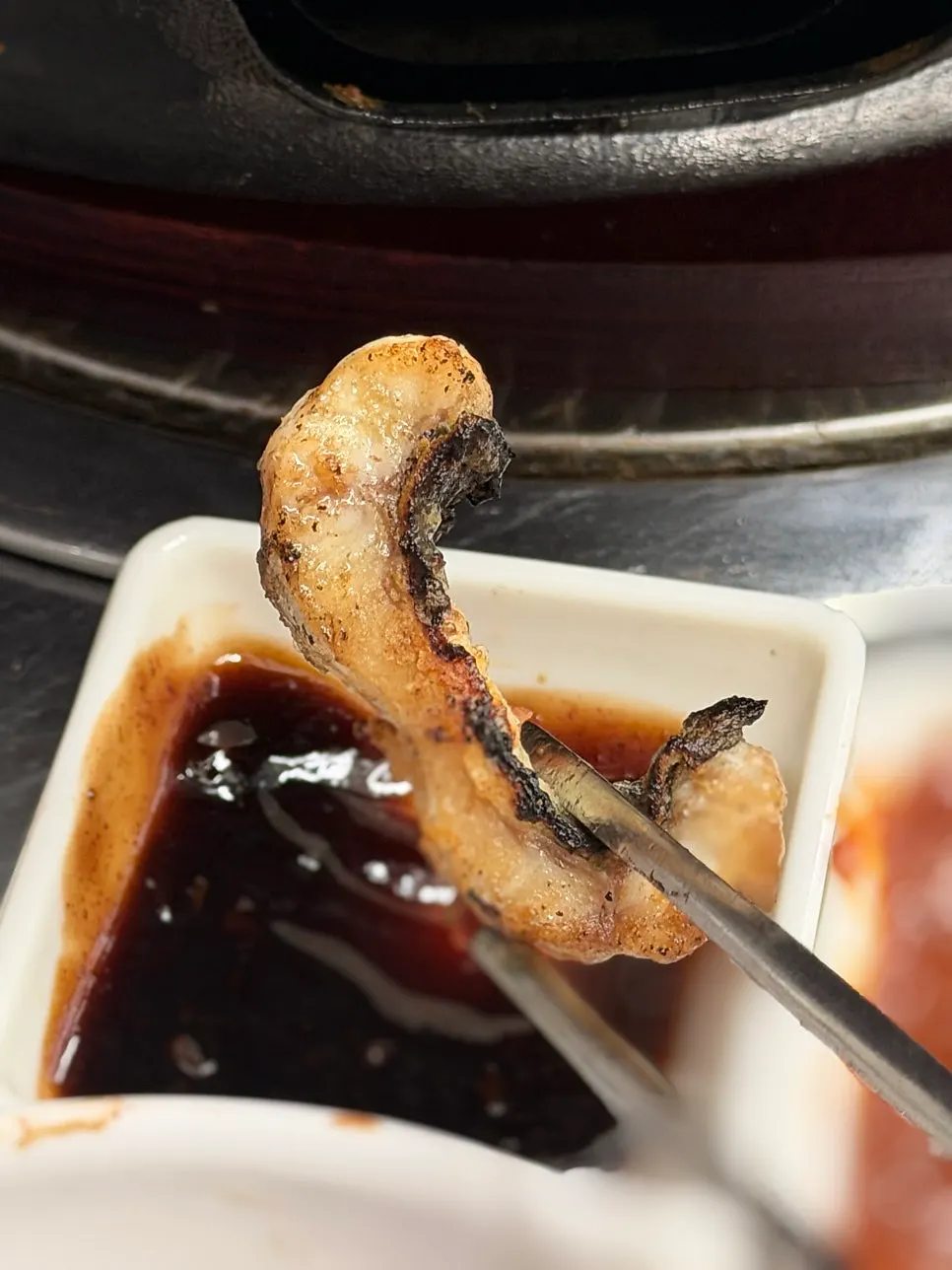 Eel being crisped on the skin side before flipping