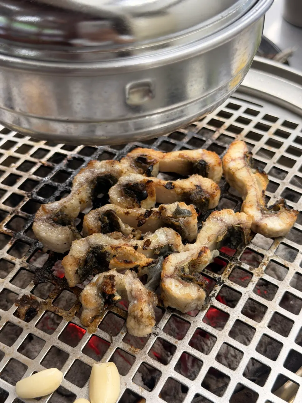 A bite of grilled eel wrapped in lettuce