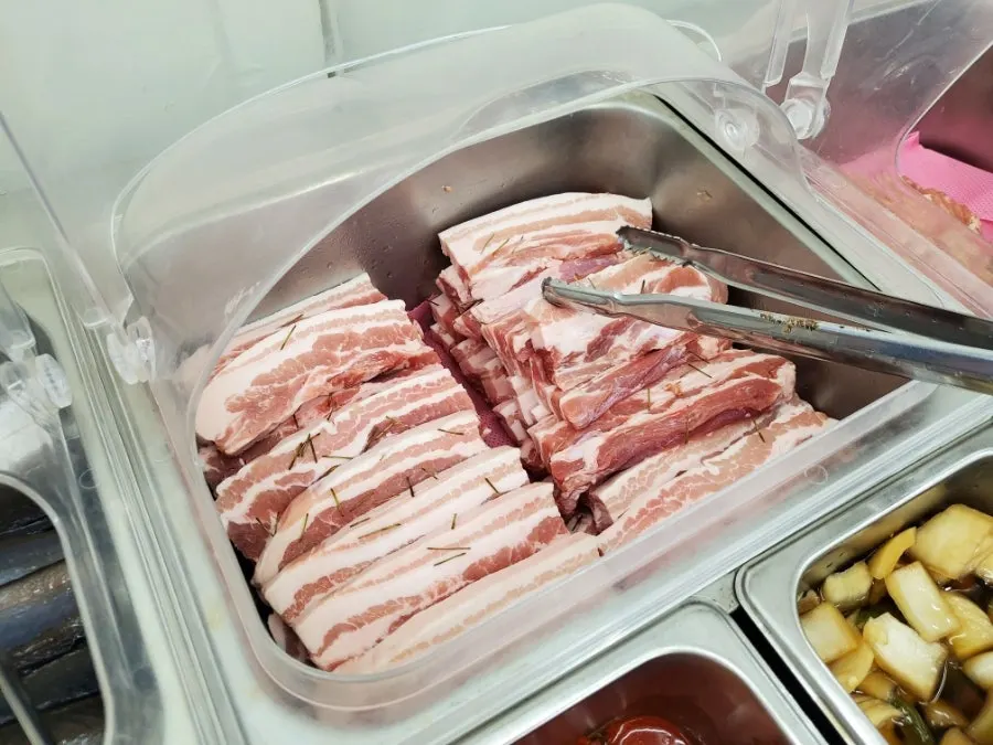Self-serve bar with lettuce, perilla leaves and other wrap vegetables