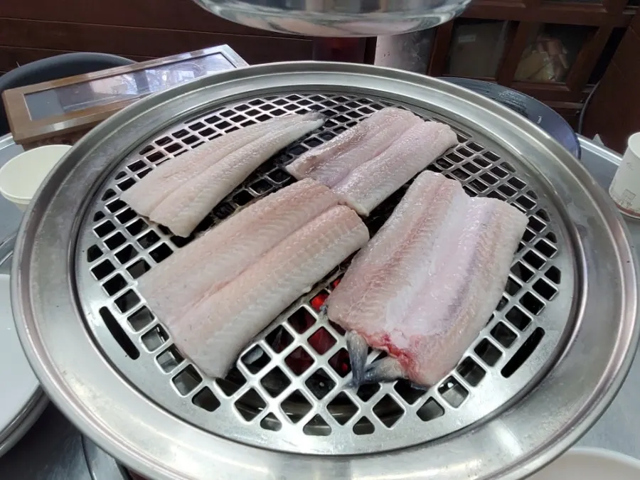 Freshwater eel being grilled starting from the skin side