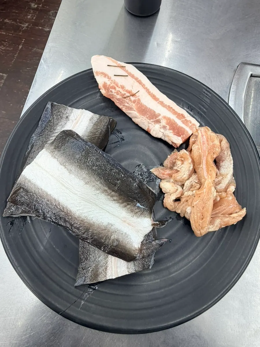 Plate with eel and meat from the unlimited refill service