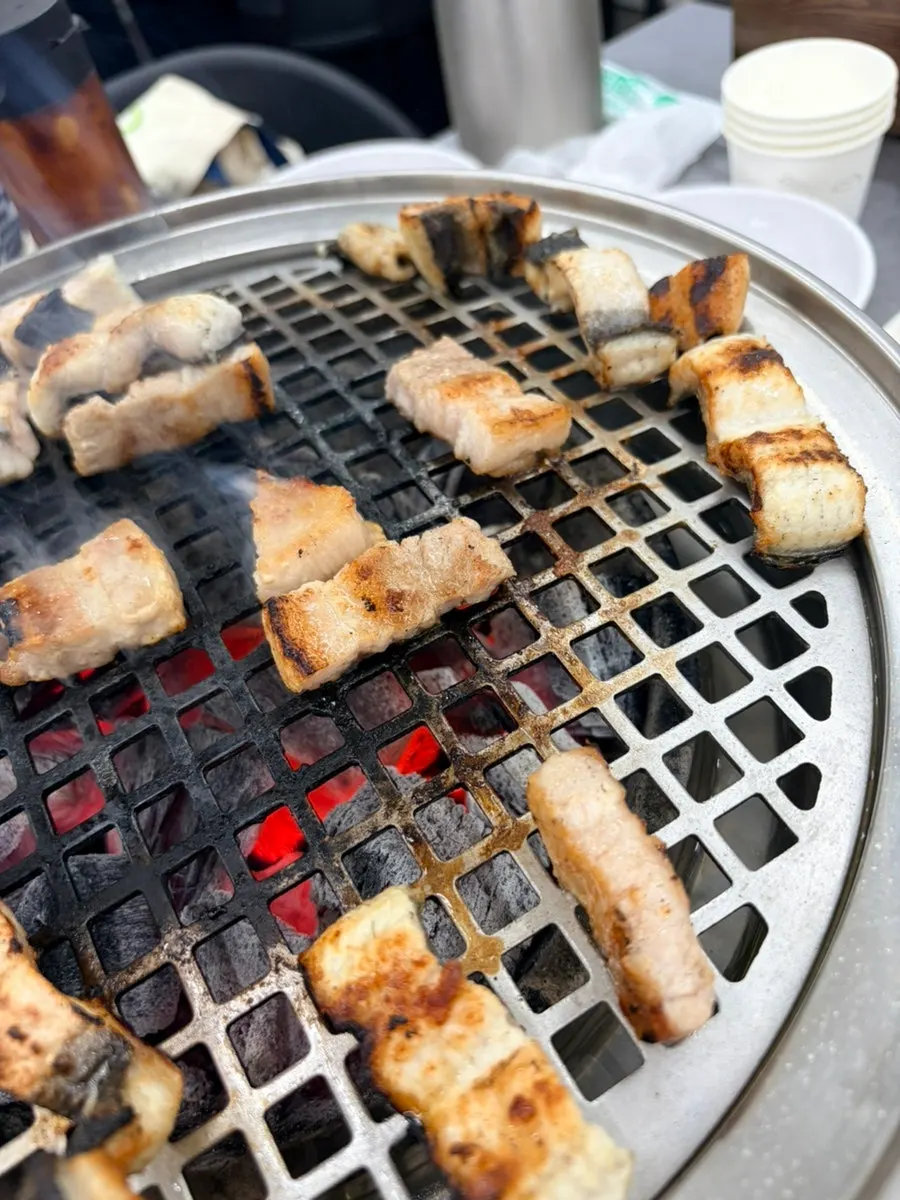 Eel turning golden brown on the grill