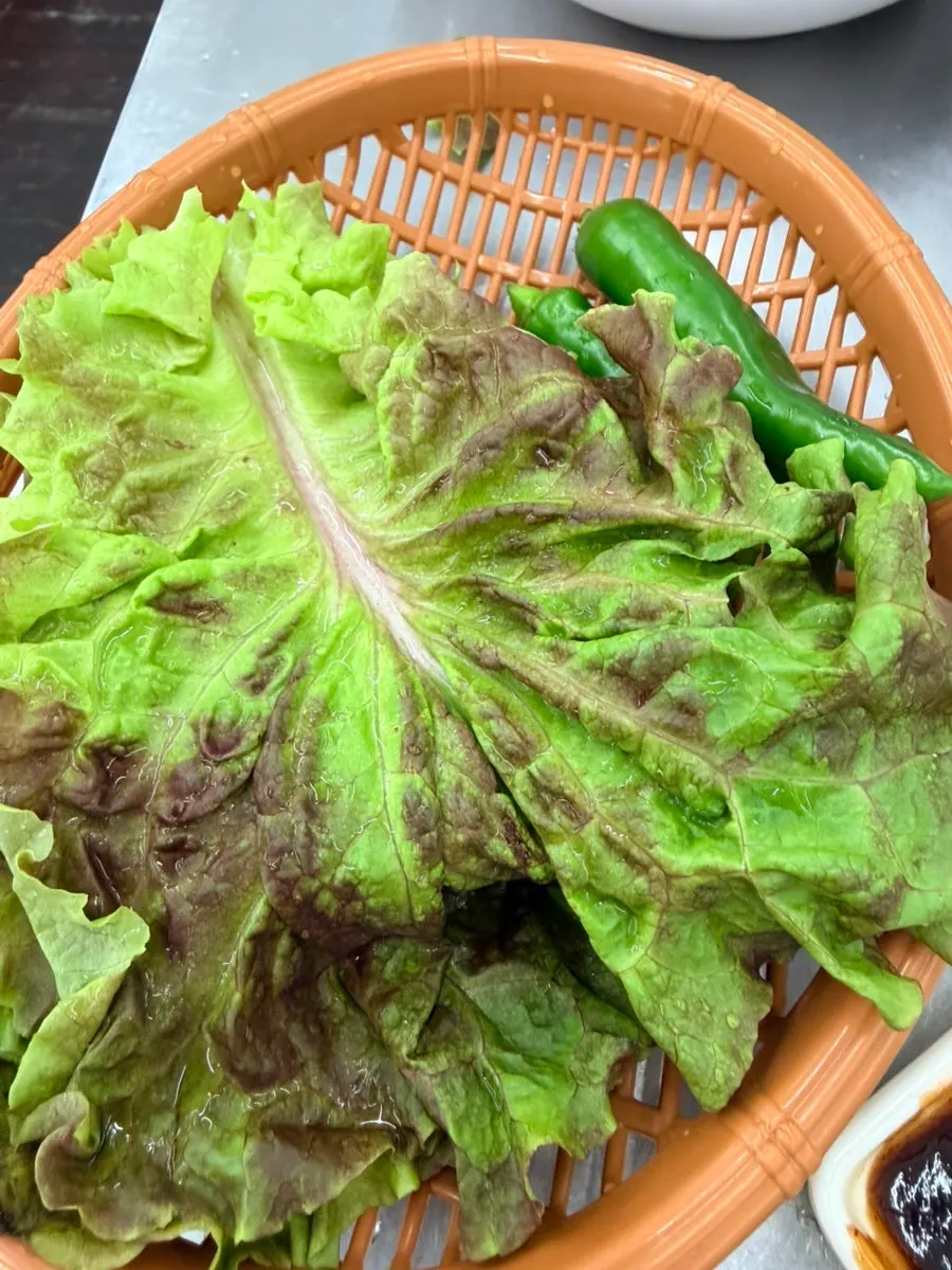 Lettuce wrap topped with rice and eel