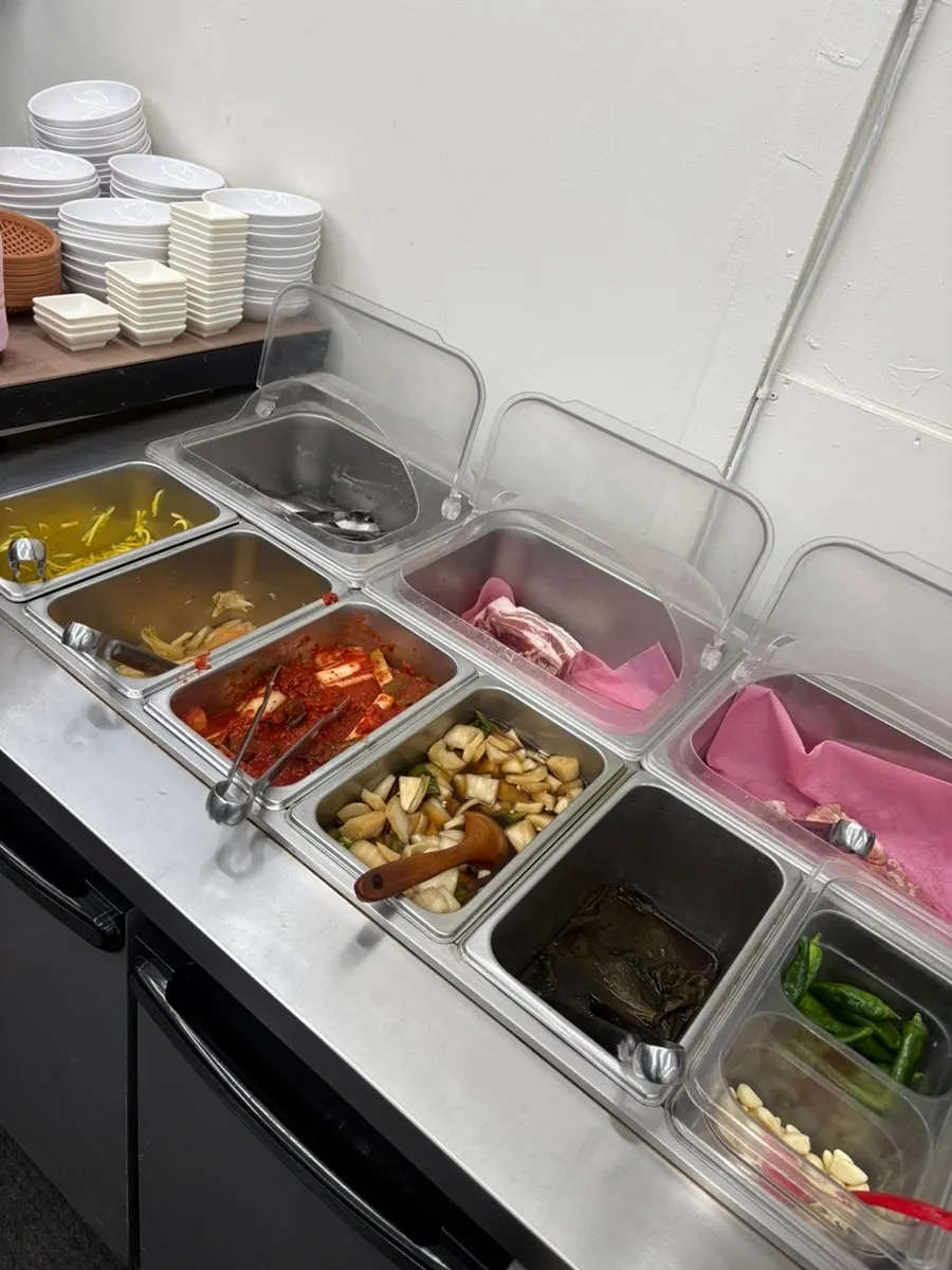 Self-serve bar with lettuce, garlic, and sauces