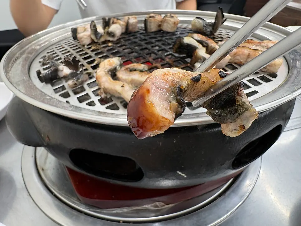 생강을 올려 먹는 구운 장어 한 점