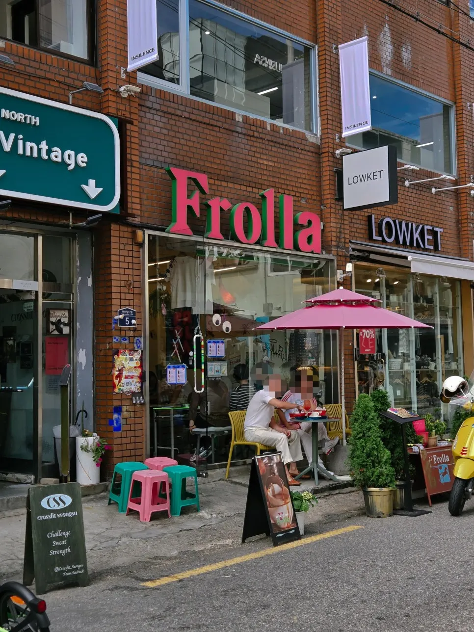 Frolla's exterior and pink parasol terrace in an alley off Yeonmujang-gil