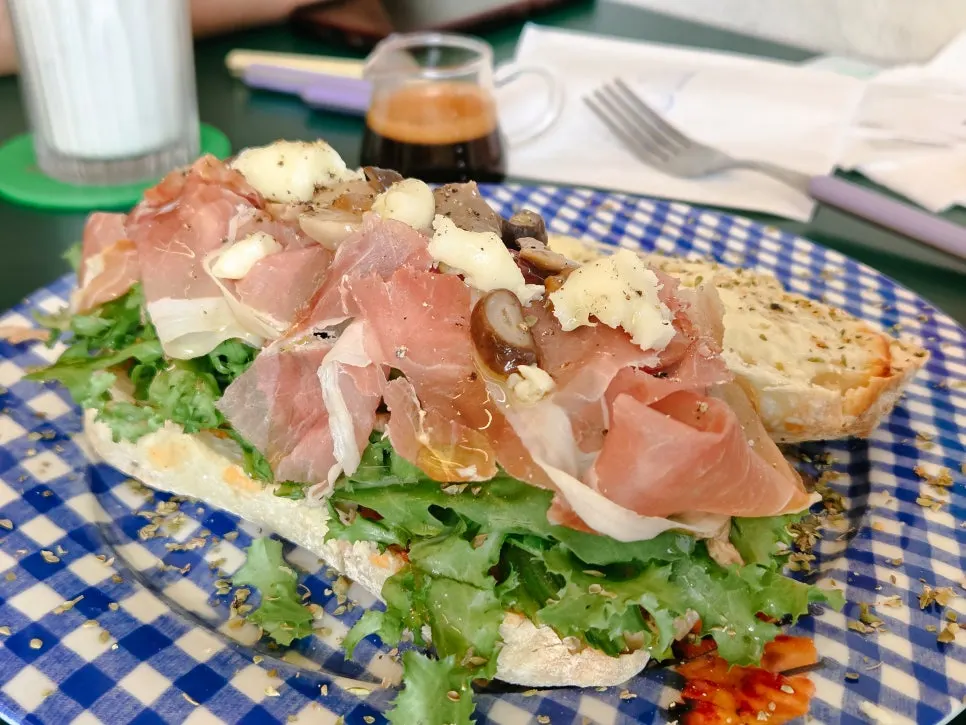 Panini with layers of parma prosciutto and arugula
