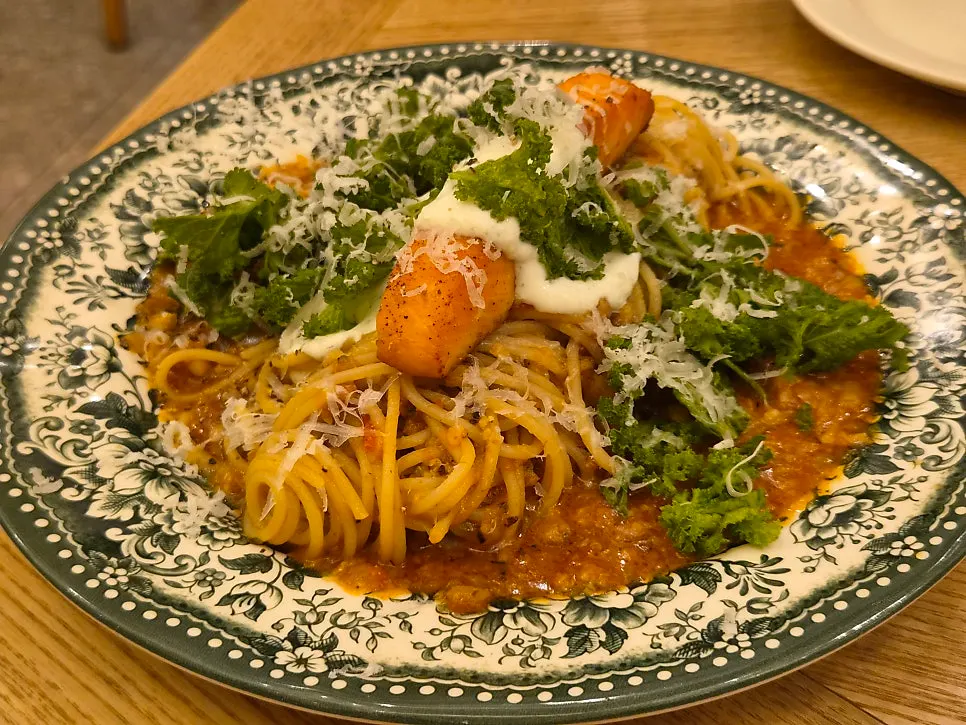 A plate of ragu-sauce salmon steak pasta